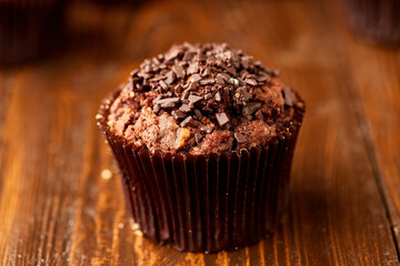 Traditional fresh dessert chocolate muffin on wooden background