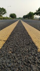 concrete road with yellow marking