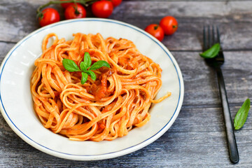 Spaghetti  bolognese .Italian home made meal Fresh  bucatini pasta with tomato sauce, basil, herbs ,parmesan cheese ,fresh cherry tomatoes and parsley on wooden background. Kitchen Poster 