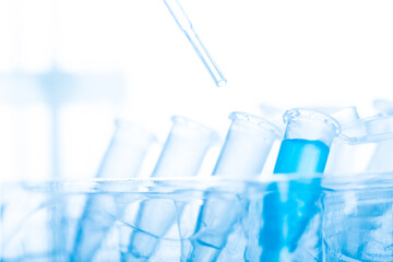 microbiological pipette in the genetic laboratory. study of a virus or vaccination. blue tinted.