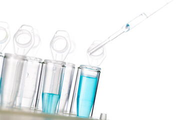 microbiological pipette in the genetic laboratory. study of a virus or vaccination. blue tinted.