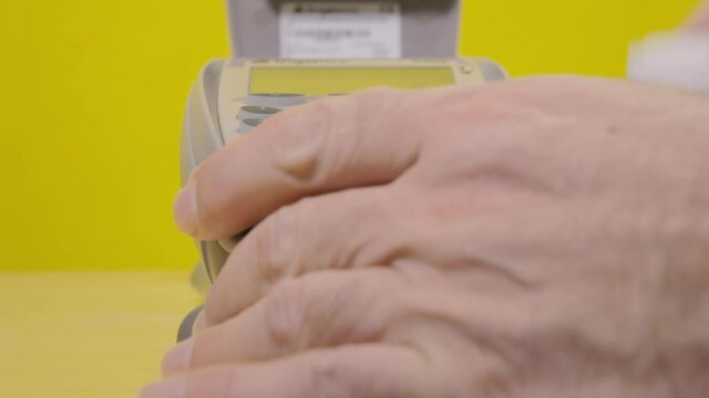 Changing the paper roll of an old POS reader. Closeup shot.
