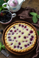 Homemade blackberry pie. Sweet pie with blackberry on rustic wooden table.
