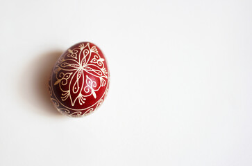 Red decorated Easter egg on white background