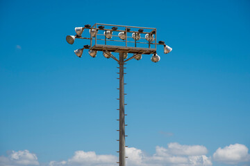 stadium lighting mast against blue sky