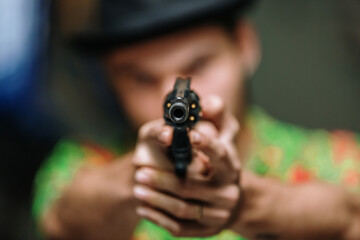 Shallow depth of focus action portrait of serious and attractive hitman or special agent man...