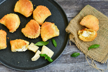 Fresh baked home made  Mini cheese puff pastries.Cheese pie with phyllo pastry and herbs