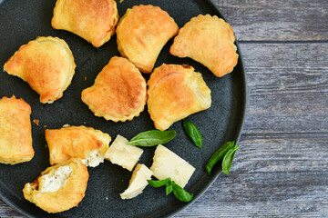 Fresh baked home made  Mini cheese puff pastries.Cheese pie with phyllo pastry and herbs