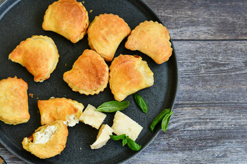 Fresh baked home made  Mini cheese puff pastries.Cheese pie with phyllo pastry and herbs