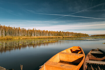 Old Wooden Rowing Fishing Boats Moored Near Lake Or River In Beautiful Autumn Sunny Day
