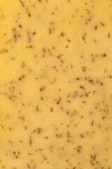 Slice of Dutch cumin cheese close up