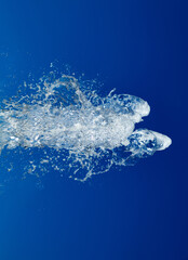 Fototapeta premium Splashing fountain against the blue sky in clear weather