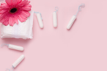 Menstruation in women. On a pink background, remedies for tampons and pads. Copy space