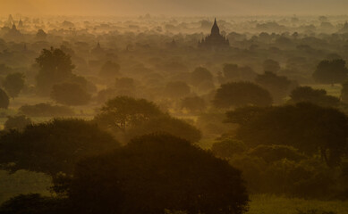 Bagan pagodas in the mist at sunrise.