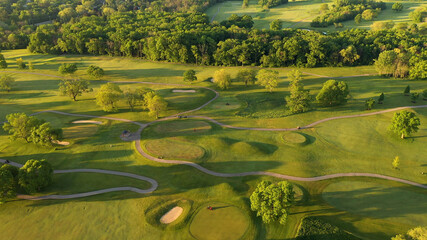 Aerial view of Golf course. Establishing shot, drone flying over golf club. Early morning,...