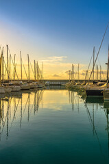 Small port with boats and reflections at sunset