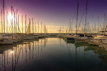 Small port with boats and reflections at sunset