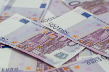Banknotes of five hundred and 500 euros are scattered in a chaotic manner. European currency blank for design, background. Side view.