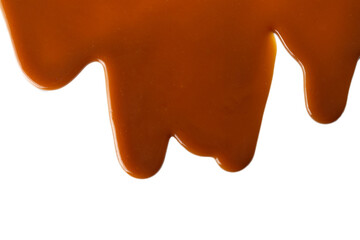 Background of flowing caramel sauce isolated on white.