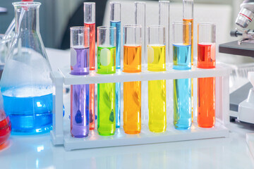 Scientist working on colorful test tube to analysis and develop vaccine of covid-19 virus in lab or...
