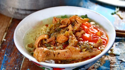 Indonesian food, mie ayam, noodles with chicken presented directly by the seller on the cart