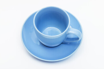 blue coffee cup and saucer on white background