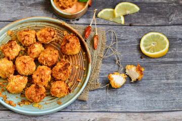  Home made Crispy Popcorn Chicken  with honey mustard sauce on wooden background
