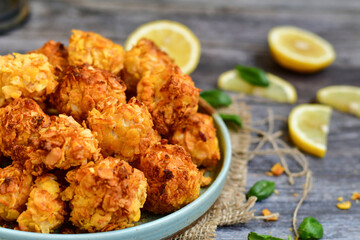  Home made Crispy Popcorn Chicken  with honey mustard sauce on wooden background