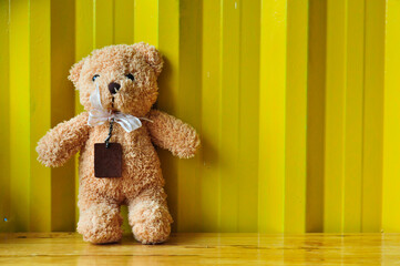 Teddy bear on yellow  background