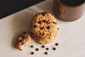 A Cup of coffee and American cookies with chocolate chips on a white background. The view from the top.