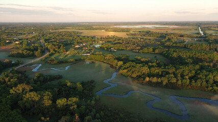 Aerial view of american countryside in the summertime. Sunrise, dawn, misty early morning. North american rural landscape,  Beautiful nature of Midwest