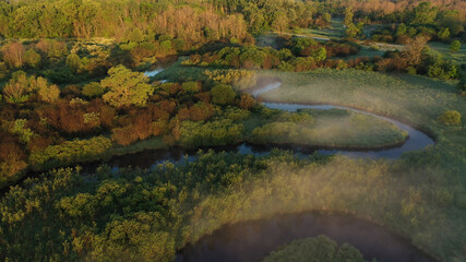 Aerial view of american countryside in the summertime. Sunrise, dawn, misty early morning. North american rural landscape,  Beautiful nature of Midwest