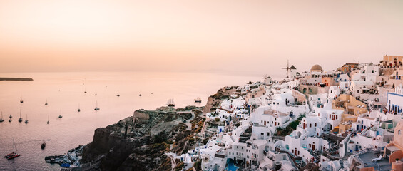 Santorini Oia Greece Europe, sunset at the white village of Oia Santorini with old blue and white...