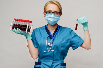 medical doctor nurse woman wearing protective mask and gloves - holding rack with virus blood tests