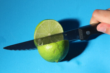 un citron vert coupé par un couteau