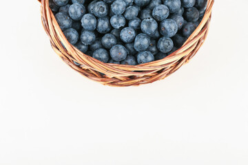 Fototapeta na wymiar blueberry berries in wicker basket close up