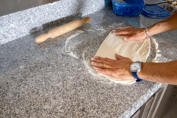 preparing the dough for pizza