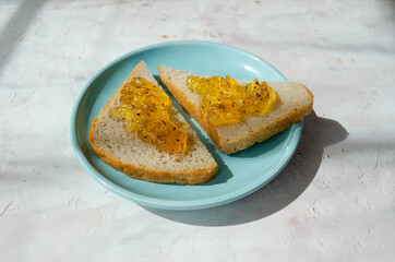 delicious Breakfast, slices of loaf with jam on a plate on a light background