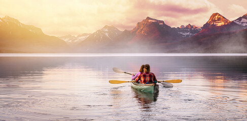 An adventurous couple in kayak paddle on a lake with rocky mountain background, Inspirational travel and leisure recreational, peaceful serene isolation - obrazy, fototapety, plakaty