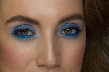 Obraz premium Beautiful macro shot of female green eye with extreme long eyelashes and smoky makeup. Perfect eyebrows and long lashes. Cosmetics and make-up. Closeup macro shot of fashion eyes visage