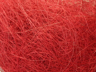 Abstract image texture is red with a chaotic mesh of thread. Christmas background.