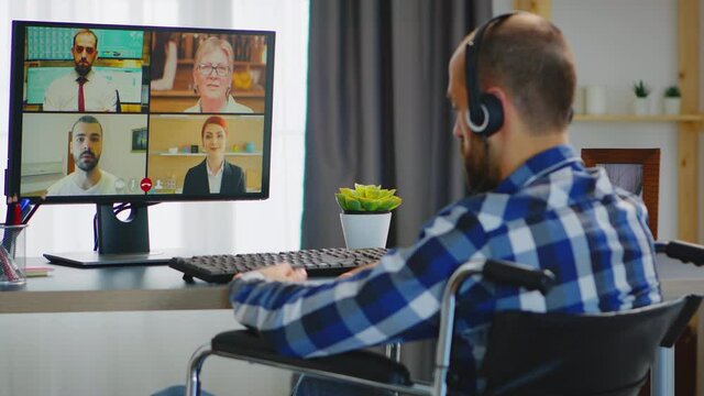 Entrepreneur with walking disability in wheelchair during an online business video call. Handicapped invalid paralysed freelancer, immobilized entrepreneur working from home, ilness and disability