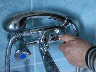 hot water shut off concept. male hand closes hot water valve