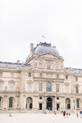Fototapeta na wymiar PARIS, FRANCE - September 17, 2019: Wonderful view of Louvre palace and unrecognizable people tourists visiting Louvre Museum. The main entrance to the Louvre Museum.
