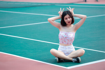 Portrait of hipsters girl pose for take a photo at tennis court,Thailand people,Lifestyle of modern thai woman