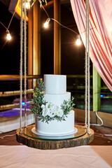 Obraz premium wedding festive multi-storey cake in white tone decorated with beautiful flowers