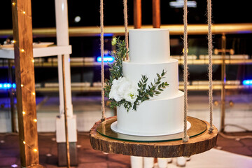 wedding festive multi-storey cake in white tone decorated with beautiful flowers