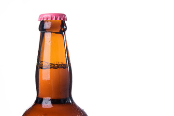 Brown beer bottles over white background. Beer with colored caps. Close up view of drinks with copy space.