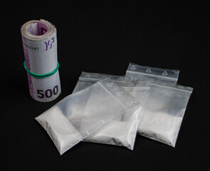 Isolated drugs in some plastic bags with a wad of five hundred euros notes