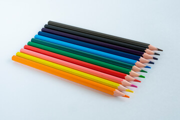 Color pencils close-up on a white background. Abstract background from color pencils